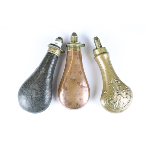 261 - Two antique copper powder flasks with brass fittings together with a leather example.