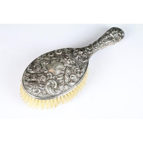 263 - A fully hallmarked sterling silver brush together with a similar hand mirror.