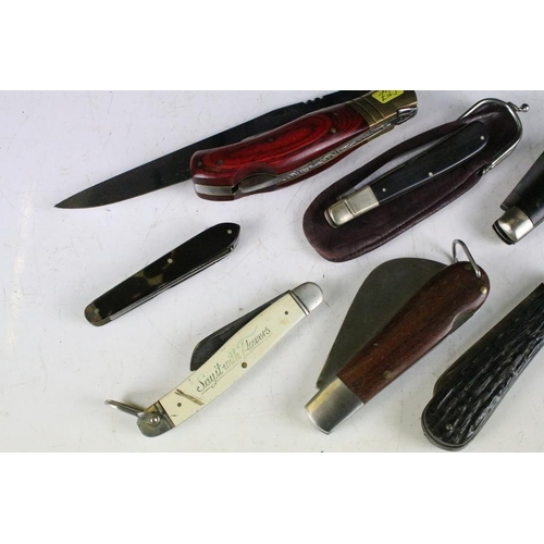 298 - A large collection of penknives to include advertising examples together with multi-tools.