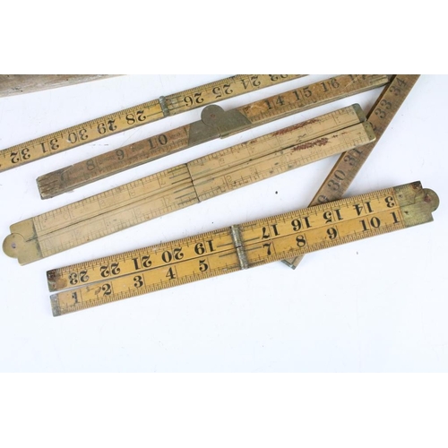 300 - A collection of sixteen vintage wooden folding rulers to include Rabone examples