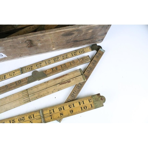 300 - A collection of sixteen vintage wooden folding rulers to include Rabone examples