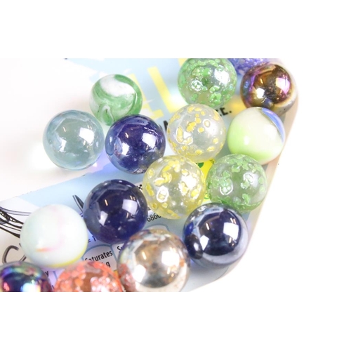 303 - A large collection of mixed glass marbles contained within six boxes.