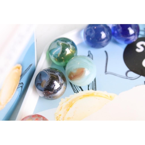 303 - A large collection of mixed glass marbles contained within six boxes.