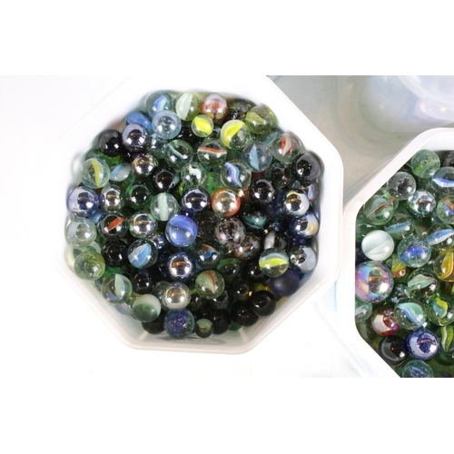 303 - A large collection of mixed glass marbles contained within six boxes.