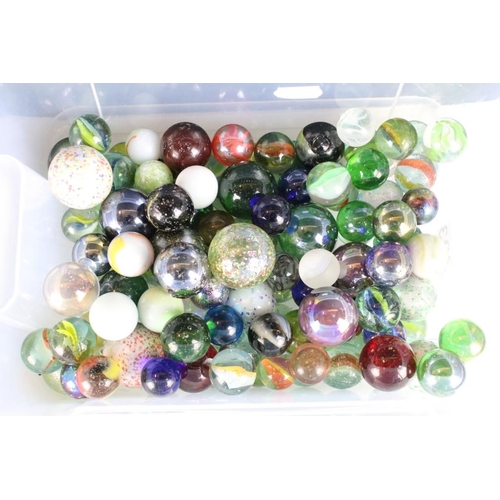 303 - A large collection of mixed glass marbles contained within six boxes.