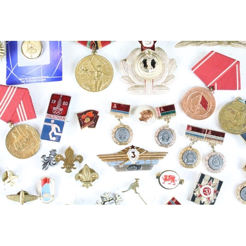 308 - A collection of Russian military medals together with a selection of Russian badges.