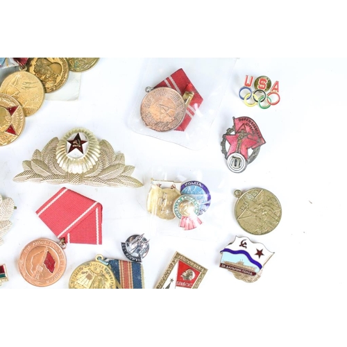 308 - A collection of Russian military medals together with a selection of Russian badges.