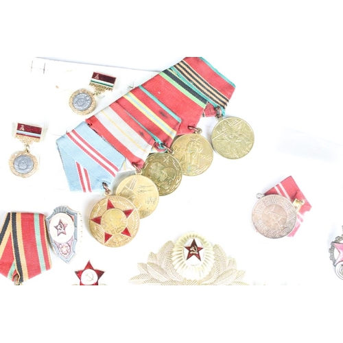 308 - A collection of Russian military medals together with a selection of Russian badges.