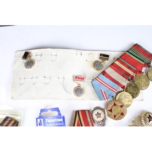 308 - A collection of Russian military medals together with a selection of Russian badges.