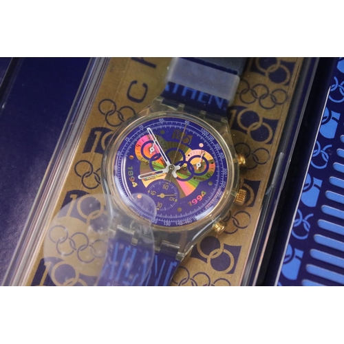 267 - A collection of four Swatch watches to include the Breakfast watch, 100 Years of the Olympic movemen... 