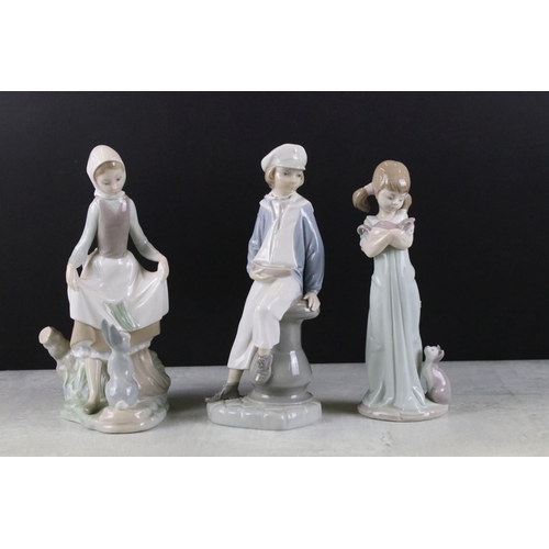 47 - Three Lladro figurines to include a boy holding a model ship, lady with a hare and a girl with a kit... 