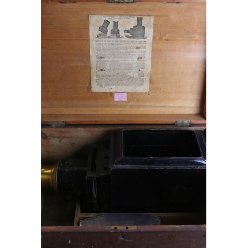 591 - Magic lantern no. 1957 (AF) in a fitted wooden box together with a long slide box and two others.