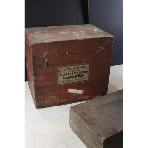 591 - Magic lantern no. 1957 (AF) in a fitted wooden box together with a long slide box and two others.