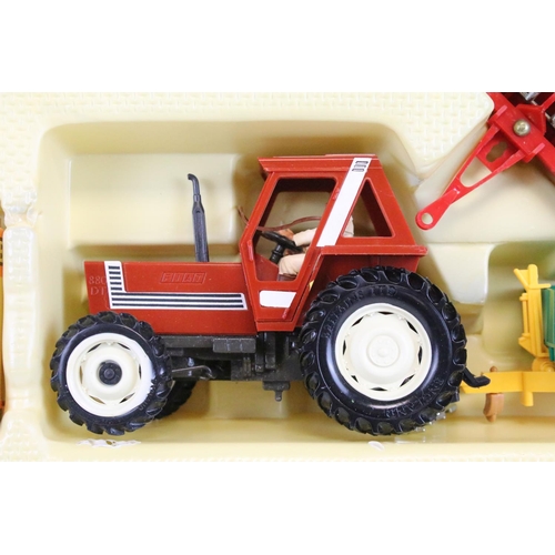 1217 - Boxed Britains 9591 Fiat Tractor and Implement Set appearing to be complete, models ex, box vg with ... 