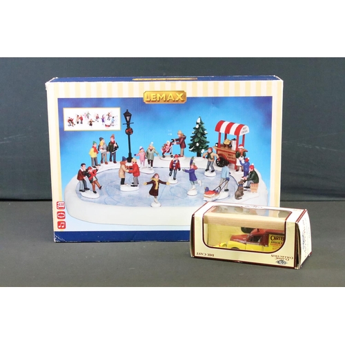 129 - Collection of seven boxed Christmas related buildings/ accessories to include 4 x Lemax fairground e... 