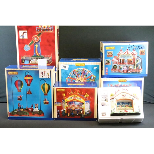 130 - Collection of seven boxed Lemax fairground buildings/ accessories to include Round Up, Circus Funhou... 