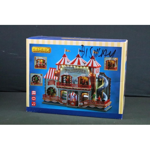 130 - Collection of seven boxed Lemax fairground buildings/ accessories to include Round Up, Circus Funhou... 