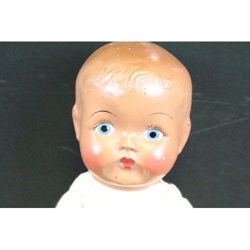 1572 - Seven assorted mid Century baby dolls to include a large baby doll with porcelain head and rotating ... 