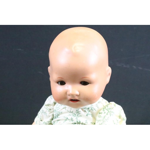 1572 - Seven assorted mid Century baby dolls to include a large baby doll with porcelain head and rotating ... 