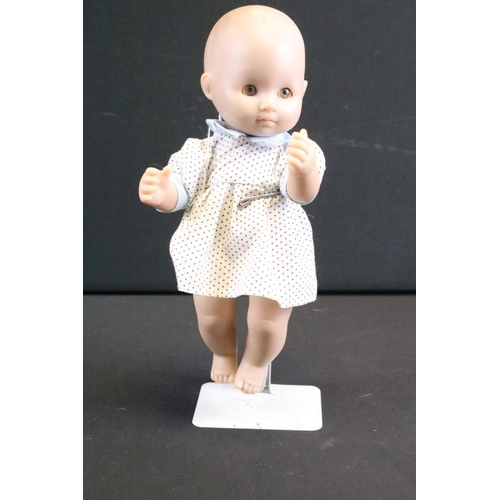 1572 - Seven assorted mid Century baby dolls to include a large baby doll with porcelain head and rotating ... 