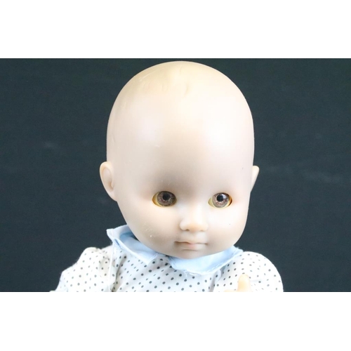 1572 - Seven assorted mid Century baby dolls to include a large baby doll with porcelain head and rotating ... 