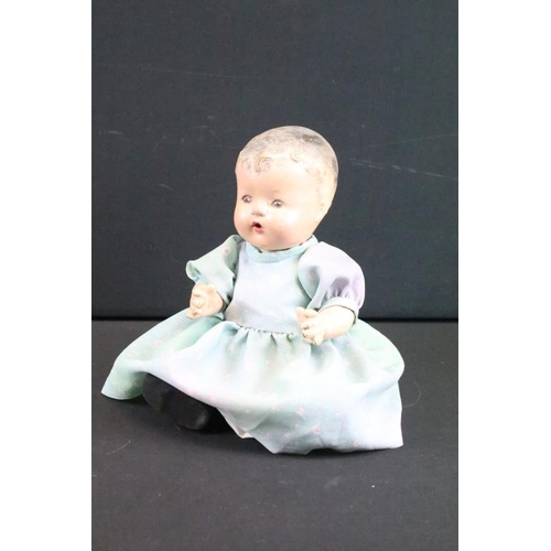 1572 - Seven assorted mid Century baby dolls to include a large baby doll with porcelain head and rotating ... 