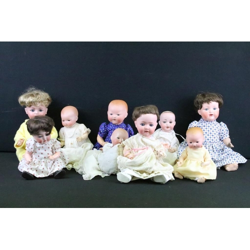 1575 - Group of nine German bisque baby dolls all having hand painted features to the faces and composite b... 