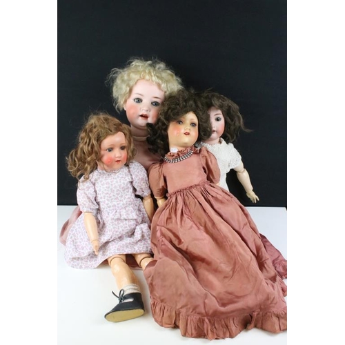 1579 - Four German bisque dolls all having hand painted details tot the heads, open mouths with teeth and s... 