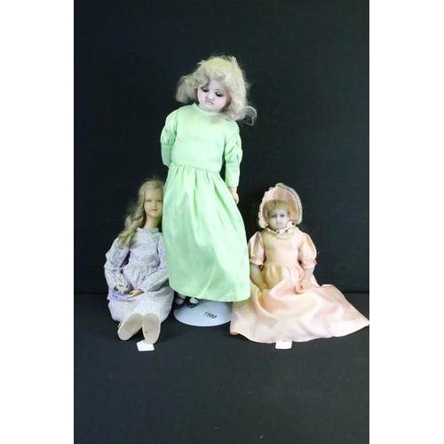 1580 - Three late 19th / early 20th century wax headed dolls to include a doll in a green dress (crack to b... 