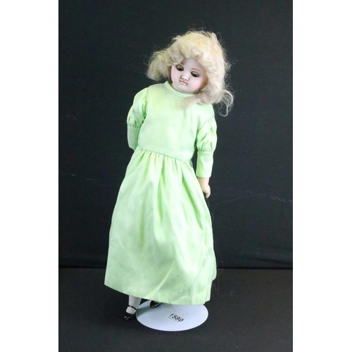 1580 - Three late 19th / early 20th century wax headed dolls to include a doll in a green dress (crack to b... 