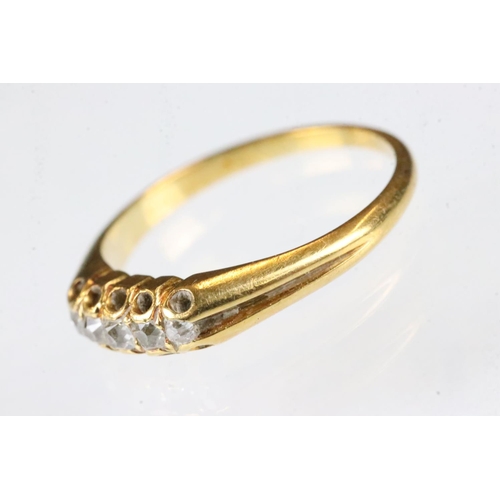 163 - Diamond yellow metal ring, five small rose cut diamonds, claw set, tapered shoulders, ring size K½