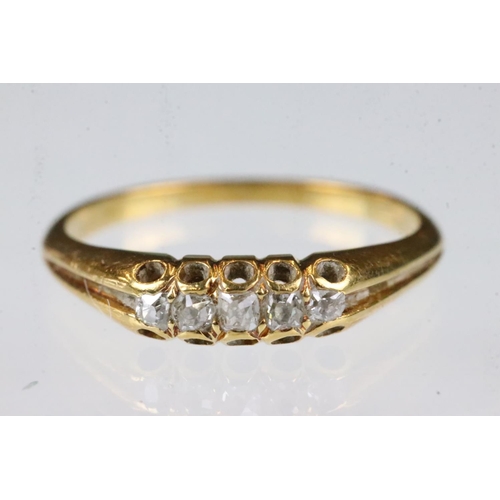 163 - Diamond yellow metal ring, five small rose cut diamonds, claw set, tapered shoulders, ring size K½