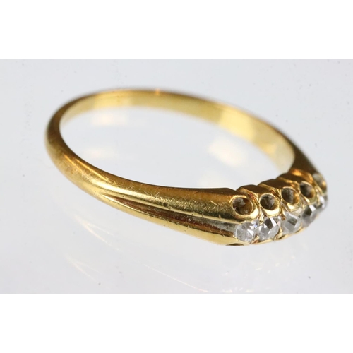 163 - Diamond yellow metal ring, five small rose cut diamonds, claw set, tapered shoulders, ring size K½