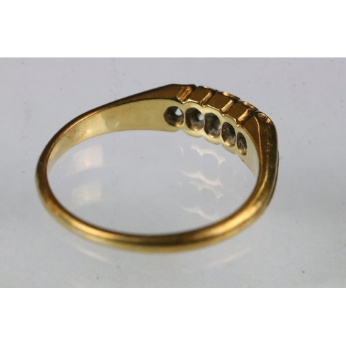 163 - Diamond yellow metal ring, five small rose cut diamonds, claw set, tapered shoulders, ring size K½