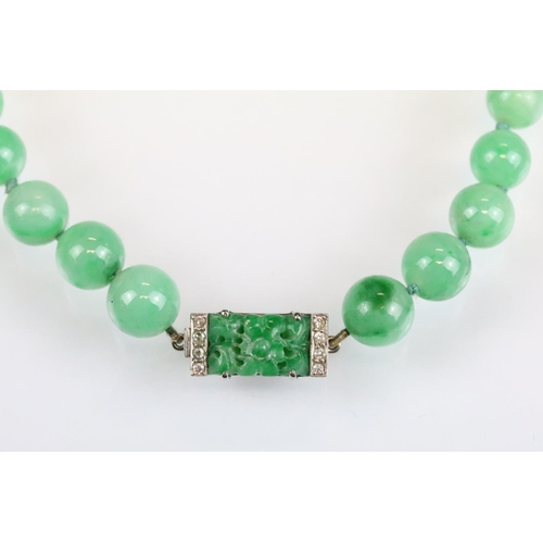 31 - Art Deco jade and diamond necklace, sixty-six graduated round jade beads, the largest diameter appro... 