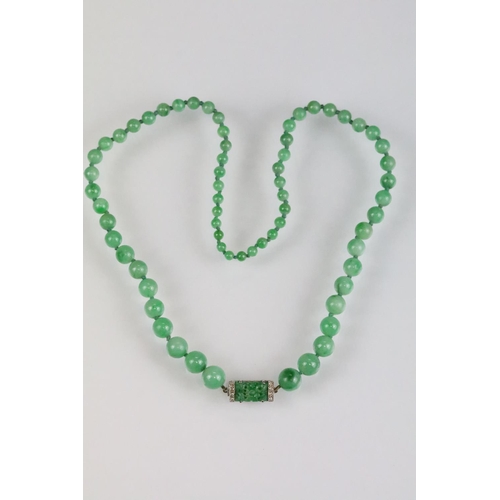 31 - Art Deco jade and diamond necklace, sixty-six graduated round jade beads, the largest diameter appro... 