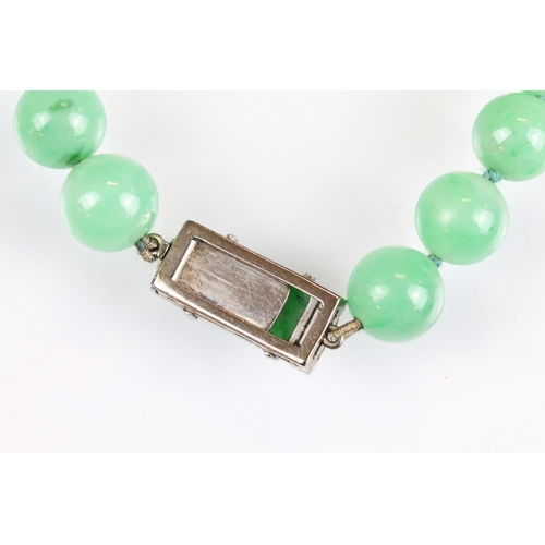 31 - Art Deco jade and diamond necklace, sixty-six graduated round jade beads, the largest diameter appro... 