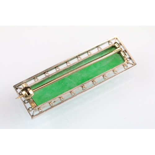 33 - Art Deco jade yellow and white metal brooch, the rectangular faceted jade measuring approx 33 x 7.5m... 