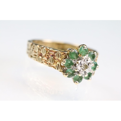 141 - Emerald and diamond 9ct yellow gold flower head cluster ring, small round eight cut diamond to the c... 