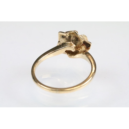 148 - Sapphire 9ct rose gold ring modelled as a rose flower, small blue-back sapphire to centre, size of h... 