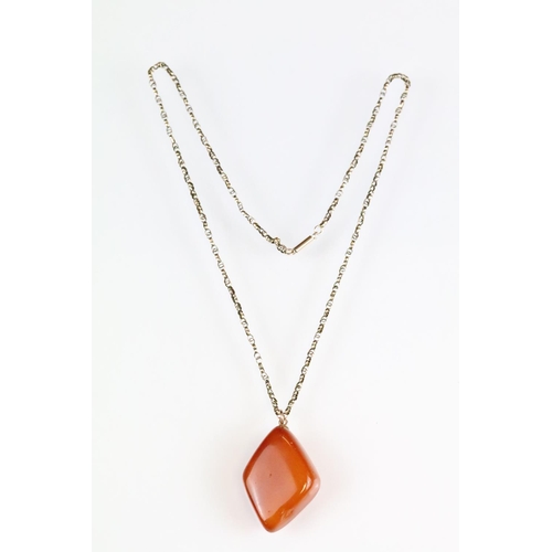 39 - Butterscotch amber-style pendant, rose metal mount, the  lozenge-shaped pendant dimensions approx 3.... 