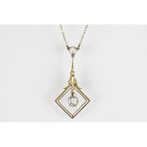 43 - Edwardian aquamarine and seed pearl 9ct yellow gold pendant necklace, the principal round mixed cut ... 