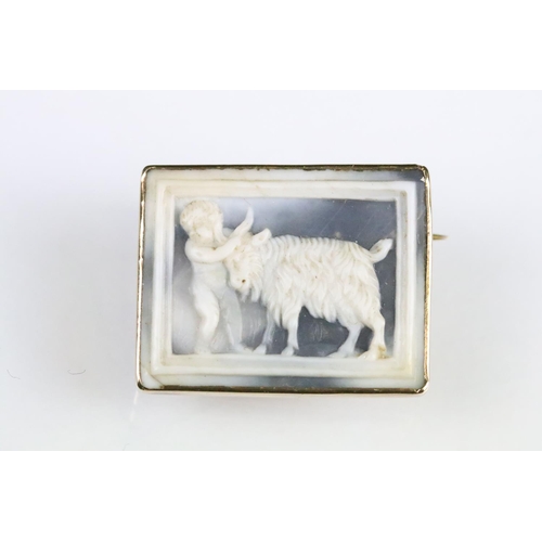 47 - 19th century yellow metal cameo depicting a goat and putto, rubover closed back setting, hinged pin ... 