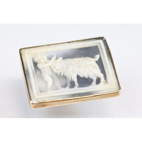 47 - 19th century yellow metal cameo depicting a goat and putto, rubover closed back setting, hinged pin ... 