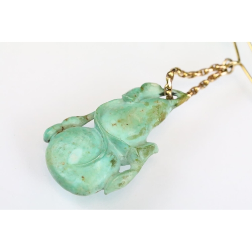 48 - Carved turquoise modelled as a double gourd with leaves, yellow metal belcher link chain suspended f... 