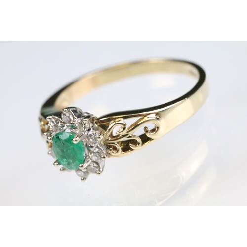 92 - Emerald and diamond 9ct yellow and white gold flower head cluster ring, the oval mixed cut emerald m... 