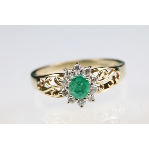 92 - Emerald and diamond 9ct yellow and white gold flower head cluster ring, the oval mixed cut emerald m... 