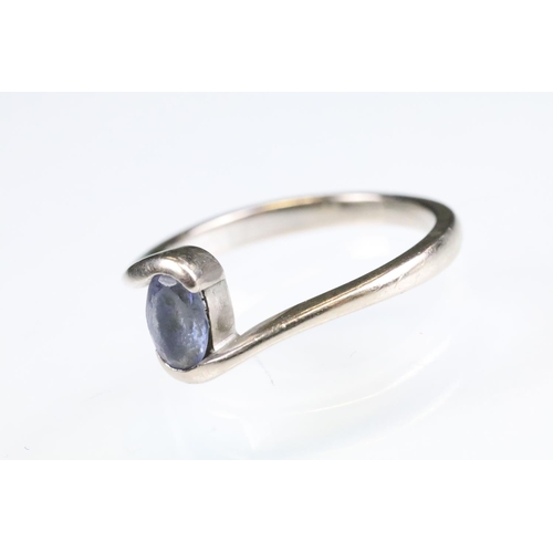 93 - Tanzanite 18ct white gold ring, the oval mixed cut tanzanite measuring approx 5.5 x 4mm, crossover s... 