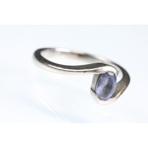 93 - Tanzanite 18ct white gold ring, the oval mixed cut tanzanite measuring approx 5.5 x 4mm, crossover s... 