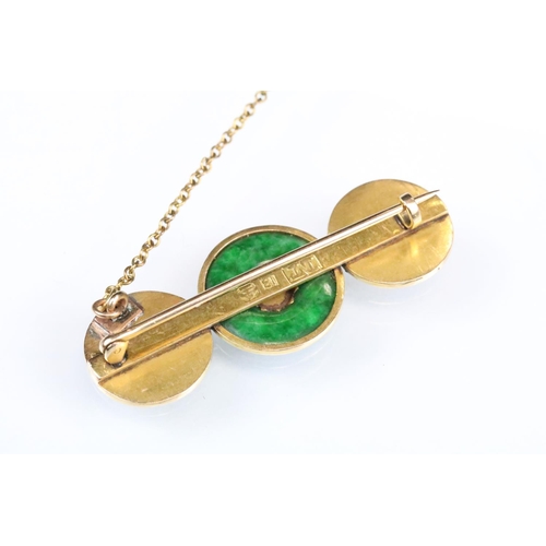 97 - Jade yellow metal bar brooch, jade disc to the centre, character mark panels either side, hinged pin... 